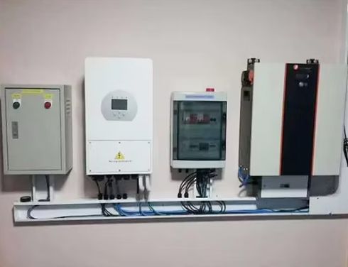 Inversor Deye 5kW híbrido instalado em parede com quadros de distribuição e proteção